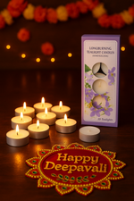 Tea light candles with a box of tea lights on a wooden surface, decorated for Deepavali.