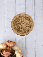 MDF Wall Plate with a circular design on a light wooden surface with flowers.