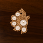 Handcrafted MDF peacock-shaped tea light candle holder with 7 lit candles, placed on a dark wooden surface, ideal for festive home décor or Diwali celebrations.