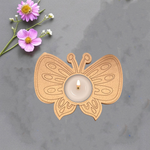 MDF butterfly tealight candle holder with premarked design and lit tealight in center on grey background with fresh flowers