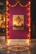 MDF wall-mounted diya shelf with festive rangoli design, marigold garlands and lit diya.