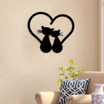 A heart-shaped wall art with two cats sitting together, adding a touch of elegance and charm to the beige-colored living room wall.
