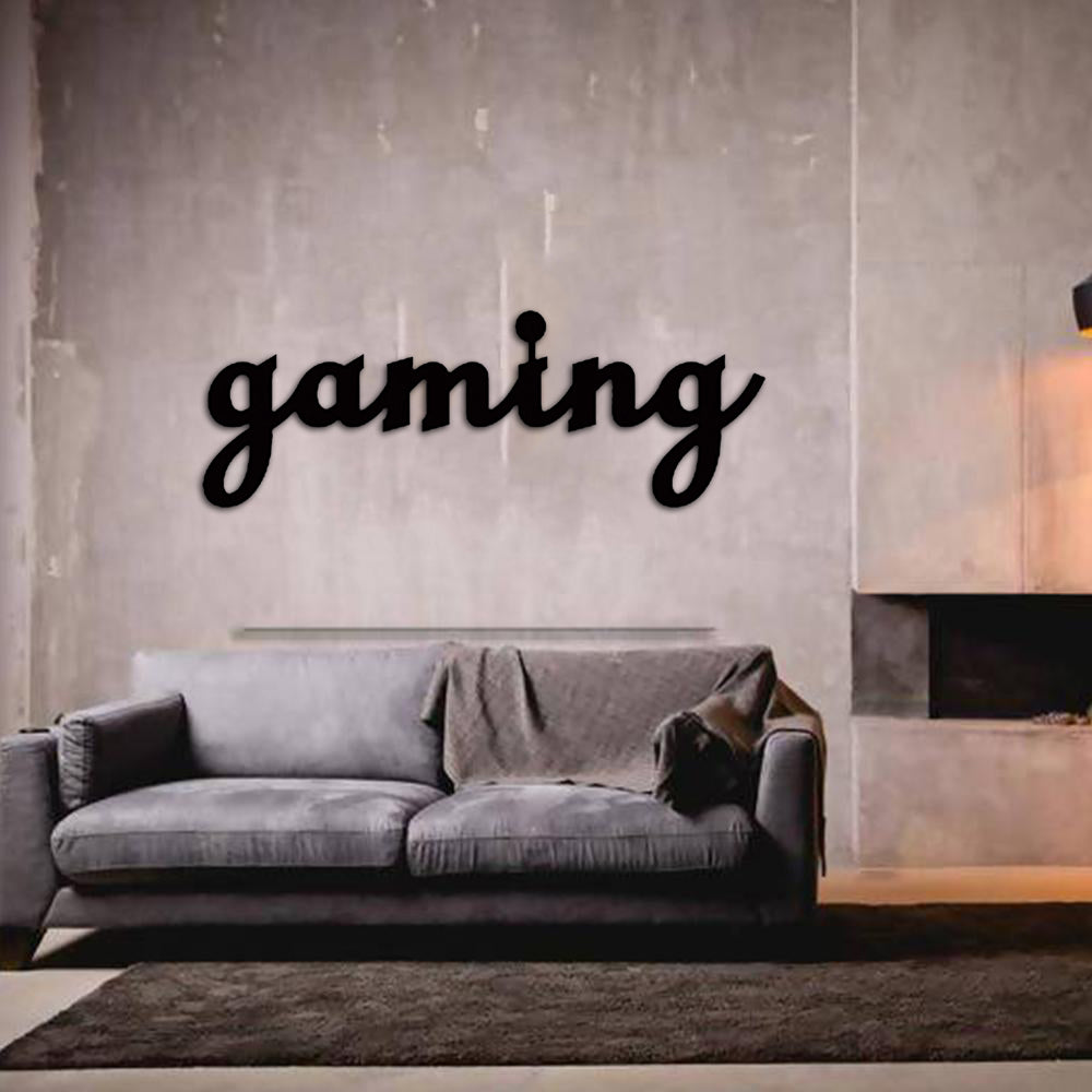 Gaming wall art in black script design mounted on a minimalist grey wall above a modern grey sofa in a cozy living space