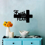 Faith Over Fear wall art with cross design, inspiring decor for home or office, displayed on a light blue wall above a cabinet with yellow flowers and a white bowl.