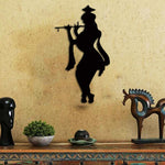 Black Krishna wall art featuring a silhouette of Lord Krishna playing a flute, mounted on a textured beige wall above a decorative wooden console.