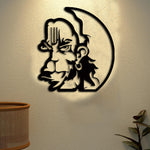 Black Lord Hanuman wall art featuring a detailed silhouette of Hanuman's face with traditional markings, mounted on a textured beige wall with soft lighting.