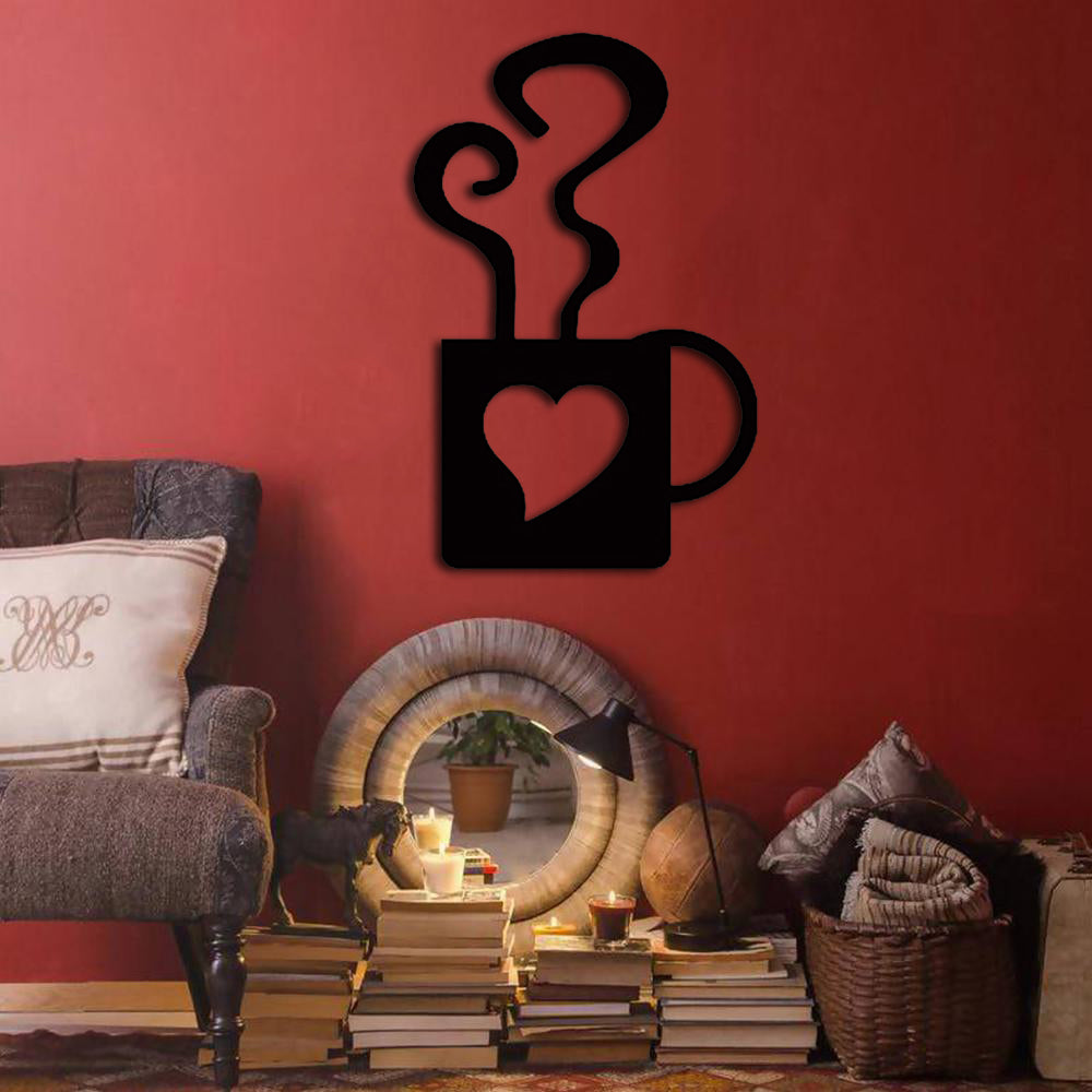 Black coffee cup wall art featuring steam and a heart cutout, mounted on a red wall above a cozy corner with books and decor accents.
