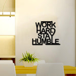 Motivational wall art with the quote 'Work Hard Stay Humble' displayed in a modern dining area.