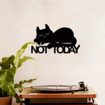 Black MDF wall art featuring a relaxed cat design with the phrase "NOT TODAY," mounted on a neutral wall above a wooden record player and green plant.