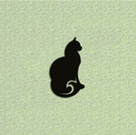 Black graceful cat wall art featuring a sleek and elegant cat silhouette, mounted on a textured green wall.