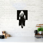 Black girl wall art featuring a silhouette of a woman walking, mounted on a white brick wall above a desk with decorative items.
