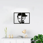 A black masculine-themed wall decor featuring a split-frame design of a man’s face, half in modern style and half with a hat and glasses, mounted on a white wall above a minimalist console table.