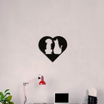 MDF heart-shaped wall art featuring silhouettes of a dog and cat, symbolizing the love for pets, mounted on a light-colored wall above a desk with a red lamp and greenery