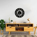 Black analog digits wall clock with a modern design displayed above a wooden console in a stylish living room.