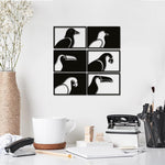 Black and white bird wall art featuring six framed designs of various bird silhouettes, mounted on a white wall above a minimalist desk with office supplies and decor.