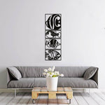 Modern fish wall decor featuring a vertical arrangement of four black frames with intricate fish designs, mounted on a white wall above a grey sofa.