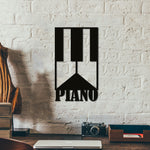 Black MDF wall art featuring a piano key design with the word "PIANO" below, mounted on a white textured brick wall above a rustic wooden desk.