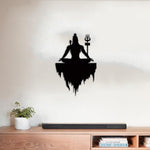 Black Lord Shiva wall art featuring a meditative silhouette of Shiva with a Trishul, mounted on a light-colored wall above a wooden console table.