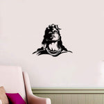 Black Mahadev wall art featuring an artistic depiction of Lord Shiva with detailed facial features, mounted on a beige wall above a cozy seating area.