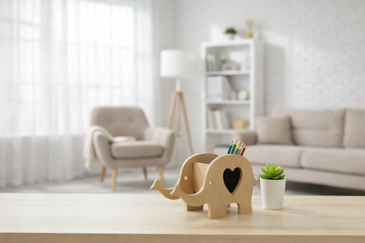 Wooden elephant-shaped pen holder with heart cutout and colorful pencils placed on a table in a bright modern living room with a small potted plant.