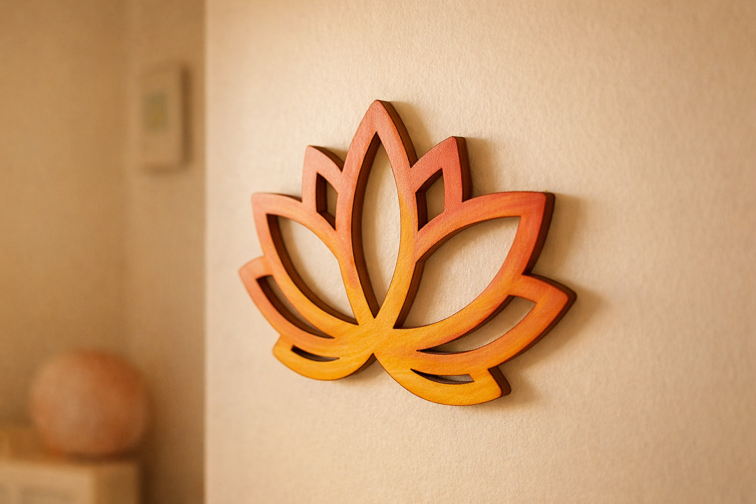 DIY Lotus MDF Cutout wall decor painted in orange and yellow gradient, laser-cut lotus design hanging on a cream interior wall.
