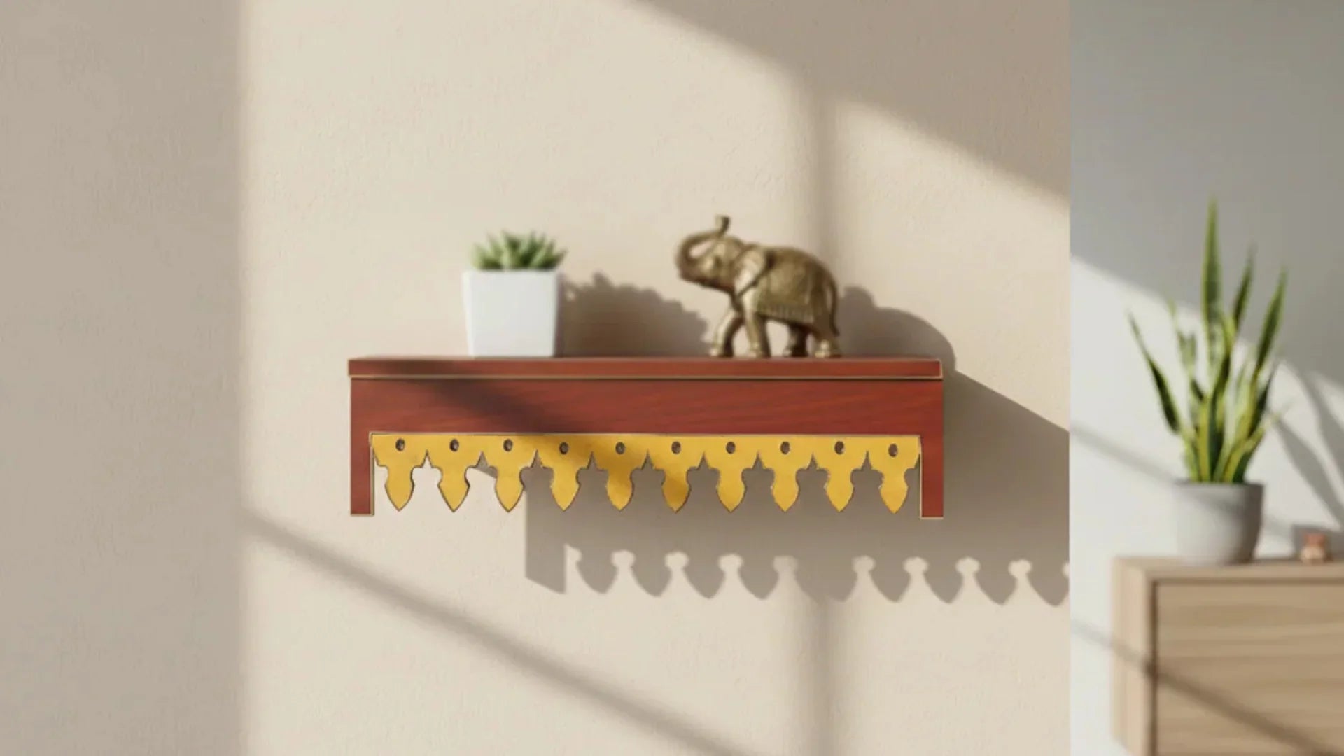Decorative wooden wall shelf with traditional carved hanging hooks, styled with a small plant and an elephant figurine against a warm beige wall.