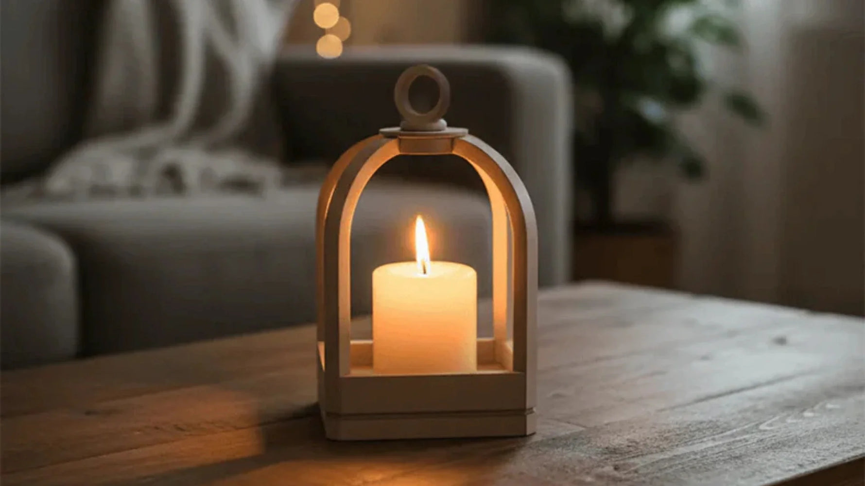 MDF lantern-style tealight holder with a glowing candle placed on a wooden table in a cozy living room setting.