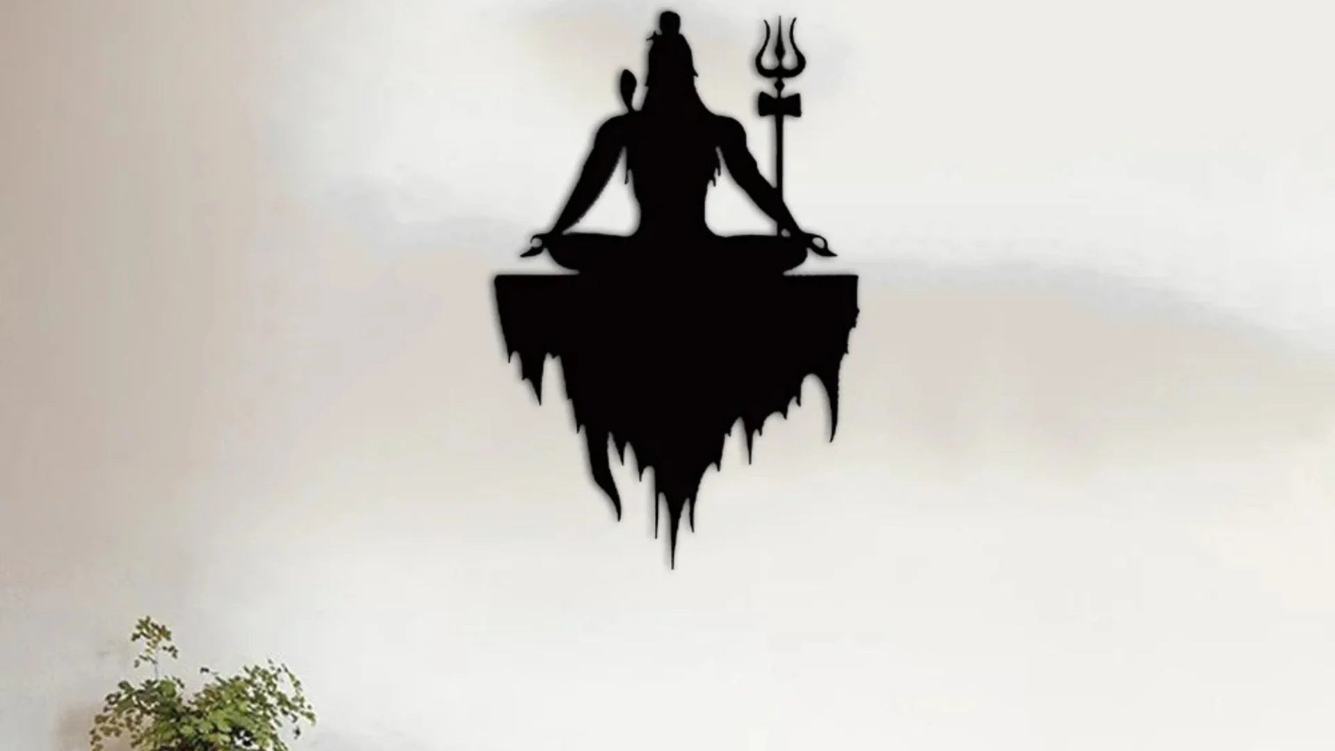 Shiva silhouette wall art in meditation pose with trishul mounted on a modern white wall.