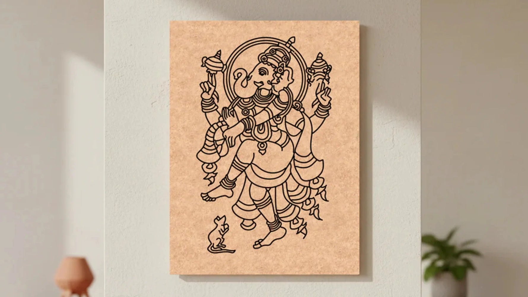 Unpainted MDF Ganesha craft base with detailed black outline artwork mounted on a neutral wall for DIY painting and traditional art projects.