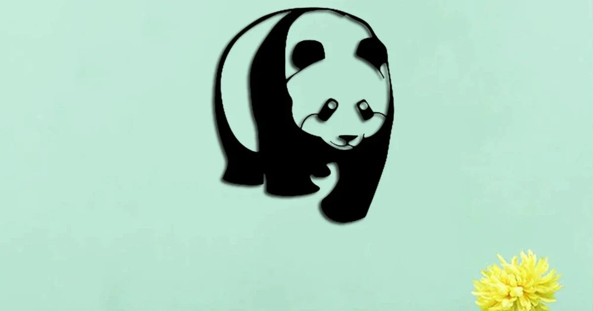 Black panda-shaped MDF wall art on a mint green background with a yellow flower.