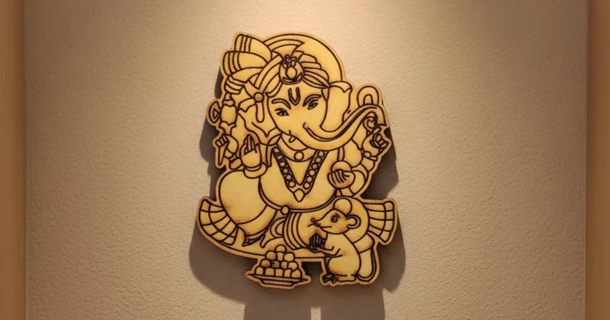 A laser-cut MDF DIY  wall art piece depicting Lord Ganesha, mounted on a beige wall under warm spotlighting.
