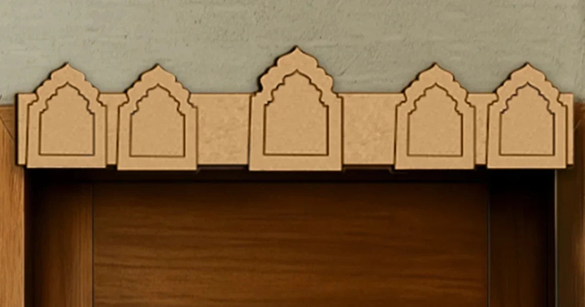 Unpainted MDF toran with five temple-arch motifs displayed above a wooden doorway.