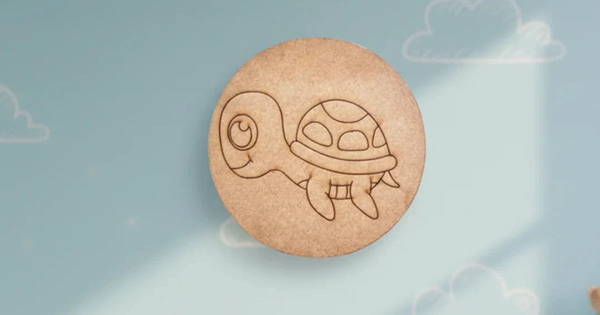 Round raw MDF craft base featuring a laser-engraved cute turtle design, displayed against a soft blue cloud-themed background.
