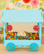 Blue painted MDF candy cart filled with colorful candies and lollipops for birthday party