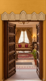 Five-arch MDF toran with symmetrical cut design – displayed on wooden door frame in natural finish.