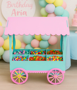DIY painted MDF candy cart with pastel pink roof and aqua base filled with colorful candies for party decoration