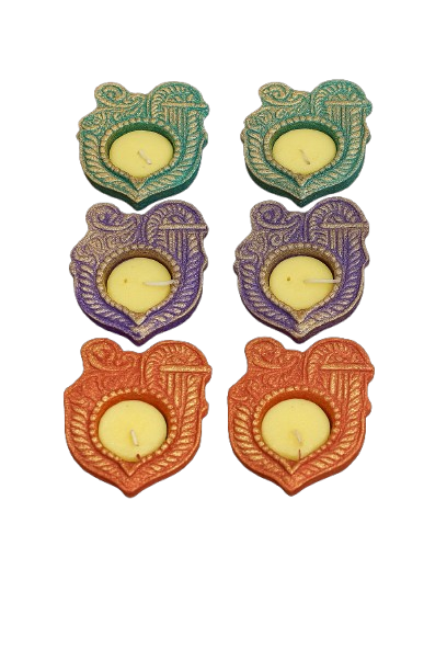 Shri‑shaped decorative diya candles arranged in colorful set for festive décor