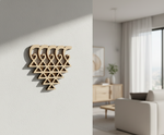MDF DIY wall art piece on a plain wall with a living room in the background