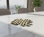 Decorative MDF DIY kolam art set on a marble table with a cityscape view in the background