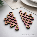 Decorative pink and black MDF DIY kolam art on a light surface with a neutral background