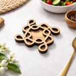Decorative MDF DIY  kolam art with intricate design on a table with a salad and flowers.