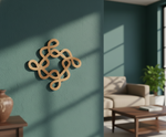 Decorative MDF DIY  wall piece on a teal wall with a living room in the background