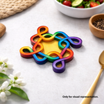 Colorful MDF DIY kolam art  on a table with a bowl of salad and flowers in the background