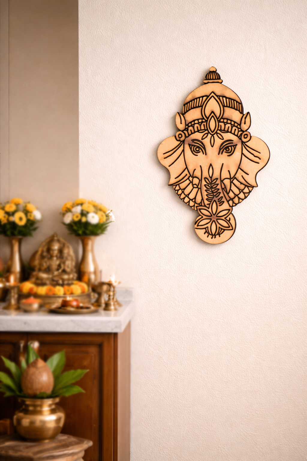 MDF DIY wall art of a deity head on a neutral wall with decorative items below.