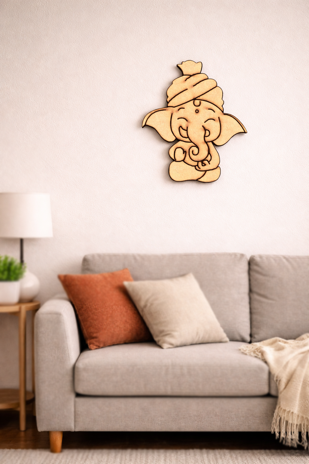  MDF DIY  wall decor of a stylized figure above a sofa with cushions.