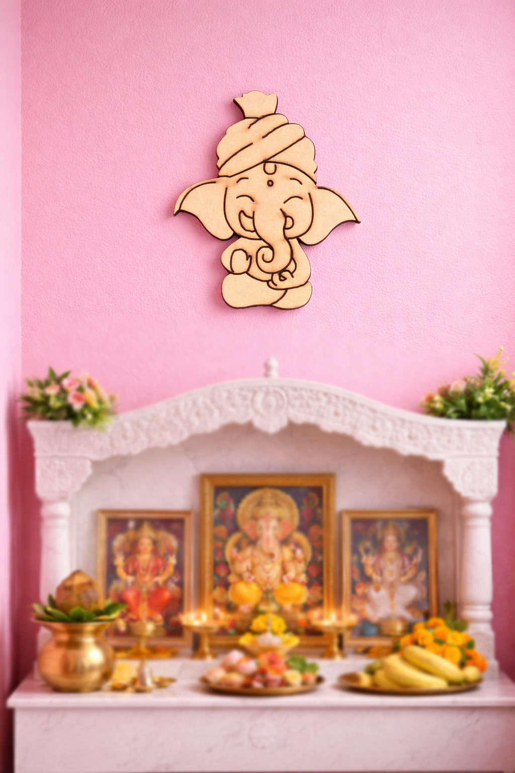 Decorative  MDF DIY  wall art of Lord Ganesha on a pink wall with an altar below.