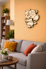Decorative MDF DIY wall art of a cartoon character on an orange wall above a gray sofa with colorful cushions.