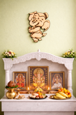 Decorative MDF DIY wall piece of a smiling deity above a white altar with religious paintings and offerings.