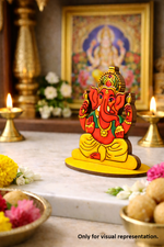 Decorative MDF DIY ganesh cutouts  on a table with flowers and candles in the background