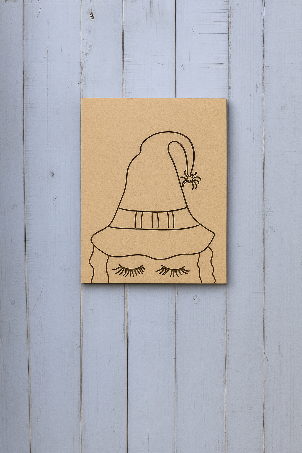 DIY traditional painting of a witch hat with spider and closed eyelashes on MDF board